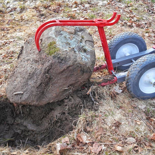 Rhino Rock Hauler prying up large stone from ground.