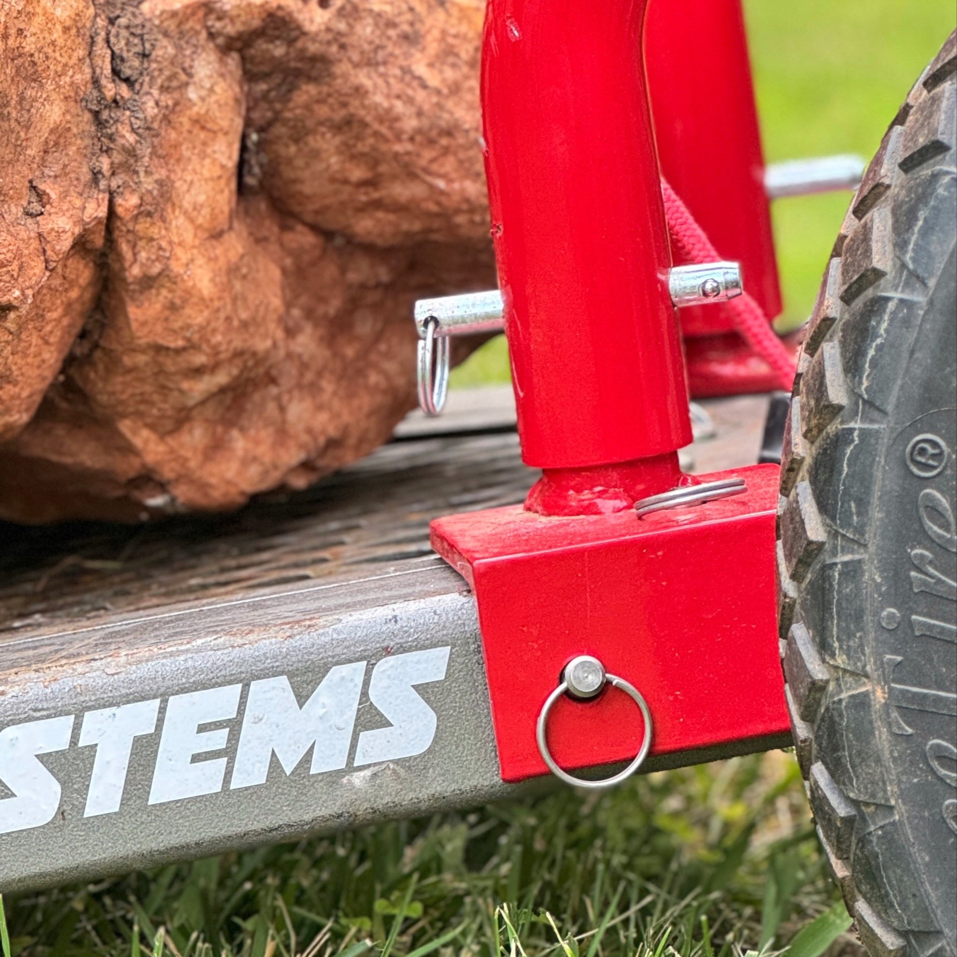 close up of red pipe with detent pin inserted in hole.