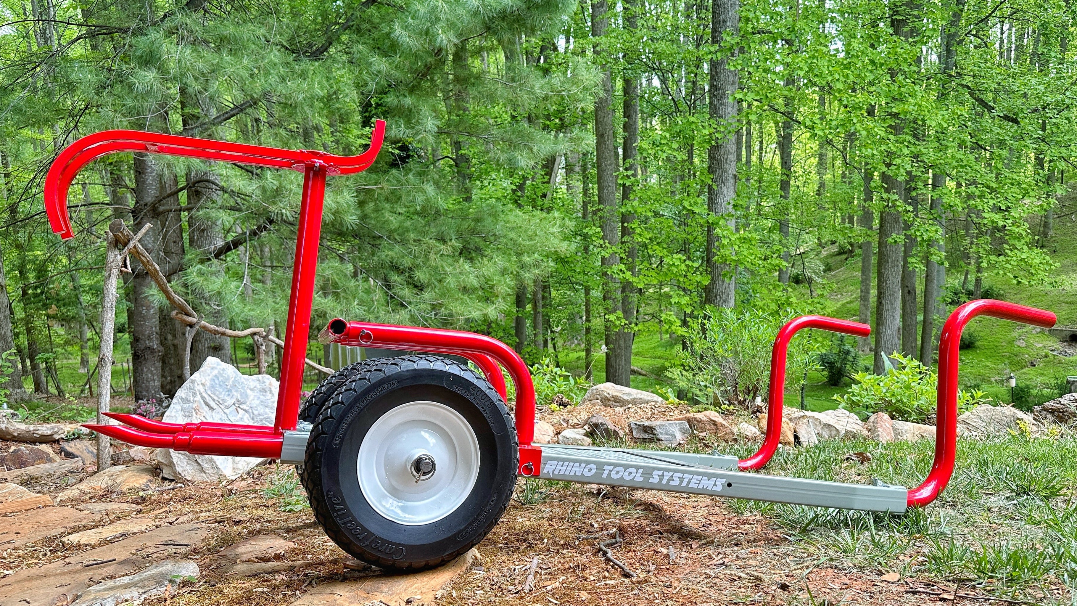 Red and gray rock moving cart seen from a profile view