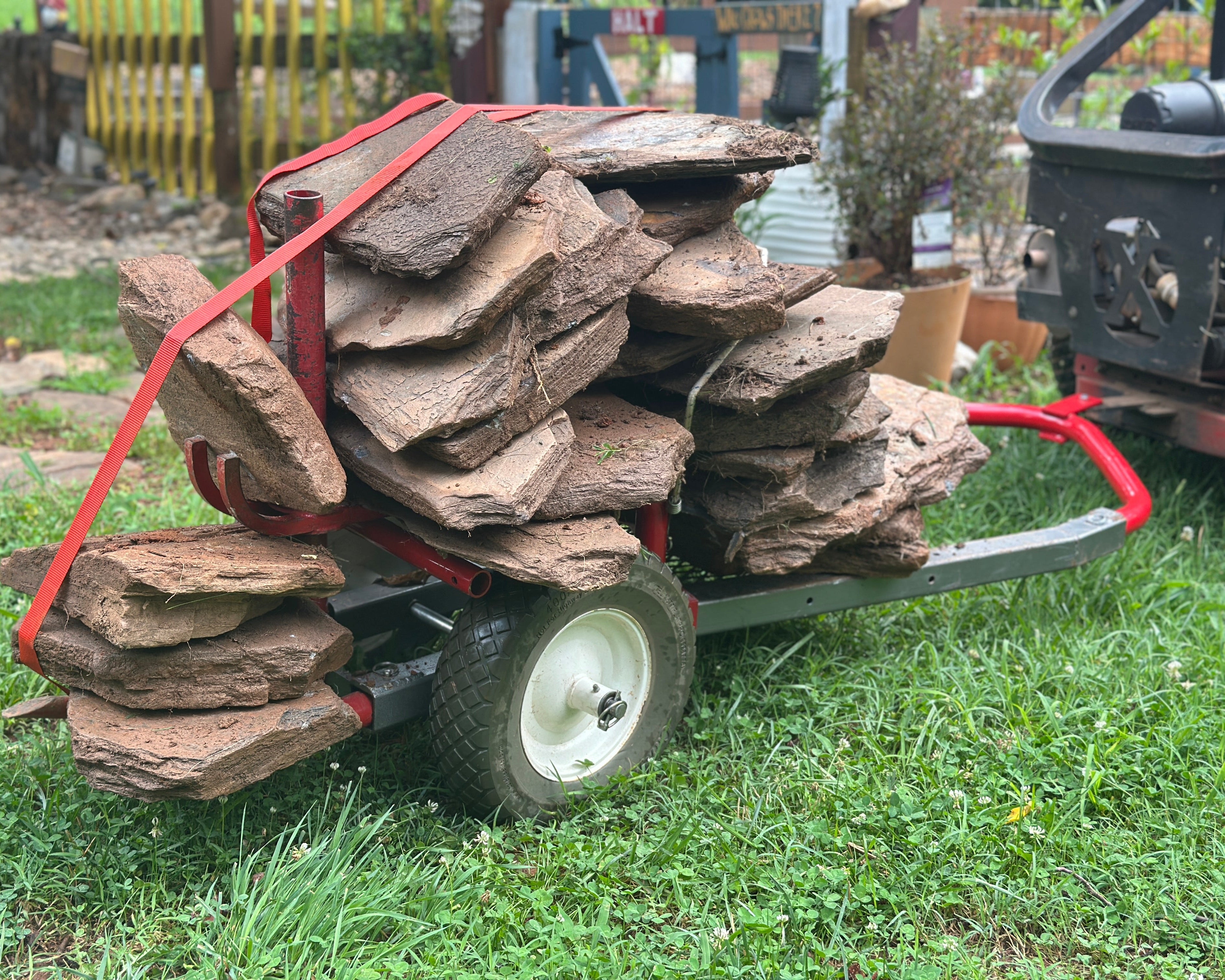 Cart loaded with large stones on a grassy area