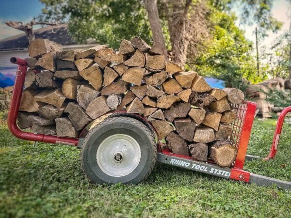 The Rhino Tool Systems Lumber Hauler landscapers cart with extensions carrying firewood.
