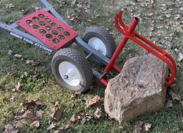 Rock hauler landscapers cart in detail about to pick up large stone